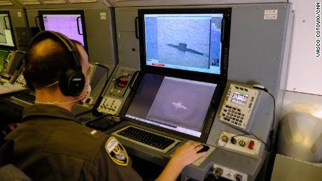 A US Navy personnel uses a P-8A camera to track a Russian Kilo class submarine as it sails across the Black Sea.