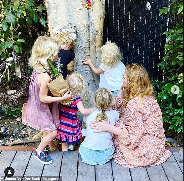 Sentimental: The actor posted a snapshot of Kimberly and their five children - Olivia, 10, Joshua, Eight, Annabelle, Six, Emilia, Four, and Gwendoline, two - huddled around a tree in the house they're moving from