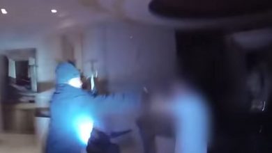 Photo of A screenshot from Bodycam depicting Las Vegas officers shooting a suspect in the robbery