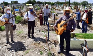 Musicians from Los Tigres de la Guasteca sing for the deceased in Pantheon San Isidro, in the municipality of Ecatepec, Mexico.