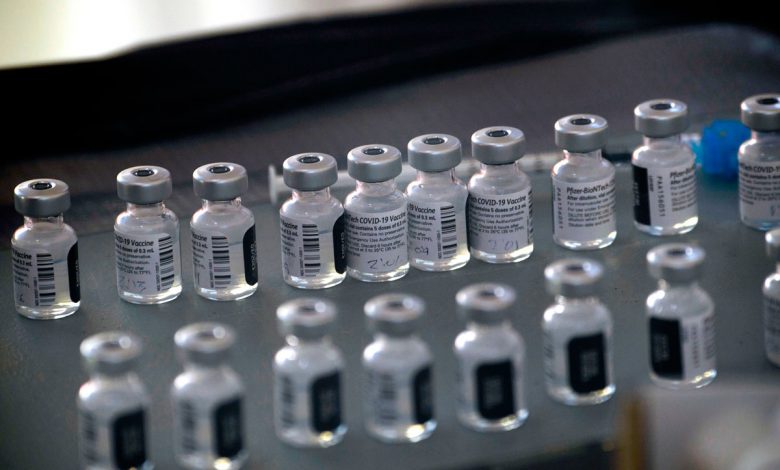 Vials of the Pfizer-BioNTech Covid-19 vaccine are prepared to be administered to front-line health care workers at a vaccination site in Reno, Nevada on December 17.