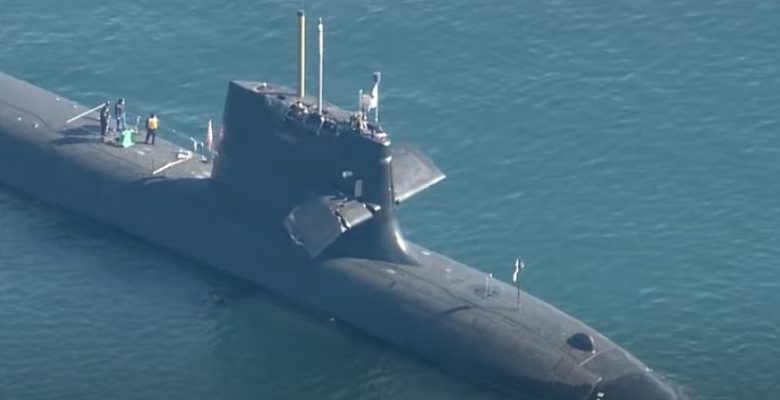 A Japanese military submarine collided with a merchant ship in the Pacific on Monday, causing severe damage.