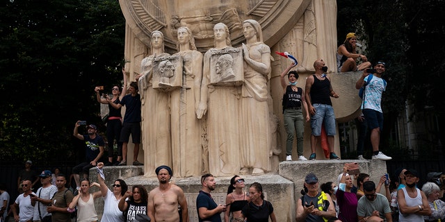 Demonstrators chant slogans during a demonstration in Marseille, southern France, on Saturday, August 7, 2021.