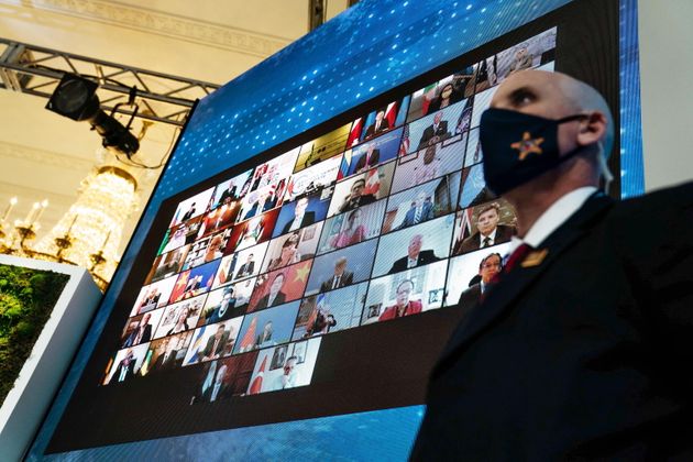World leaders are projected onto a screen in the East Room of the White House during the Virtual Leaders...