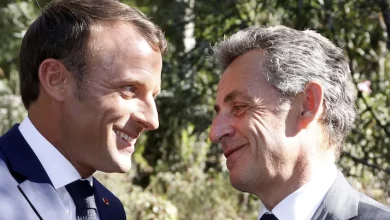 Photo of Nicolas Sarkozy stood by Macron