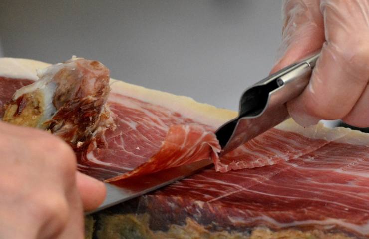 Man cutting raw pork