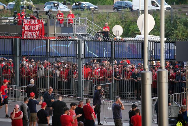 Liverpool fans line up to enter the stadium as kick-off before the UEFA Champions League Final is postponed at the Stade de France in Paris.