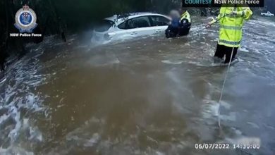 Photo of Australia floods, 72-year-old stuck in car rescued by police