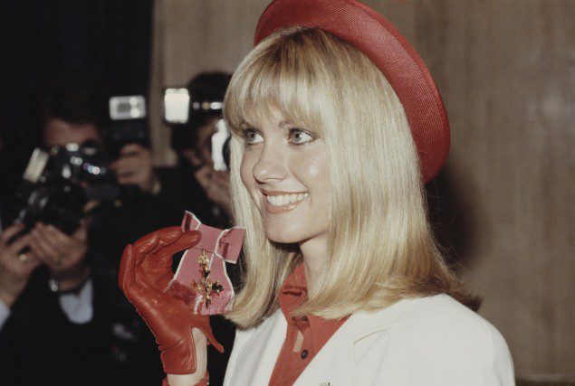 Australian actress and singer Olivia Newton-John receives the Medal of Academic Excellence at Buckingham Palace in London, UK, March 13, 1979 (Photo by Keystone/Hulton Archive/Getty Images)