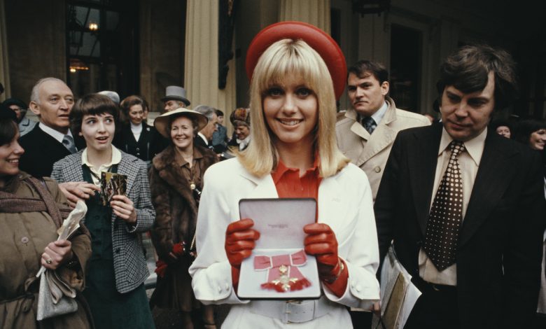English born Australian singer and actress Olivia Newton-John pictured holding her award after receiving the Order of the British Empire (OBE) from Queen Elizabeth II during an Investiture ceremony at Buckingham Palace in London on 13th March 1979. (Photo by Rolls Press/Popperfoto via Getty Images/Getty Images)